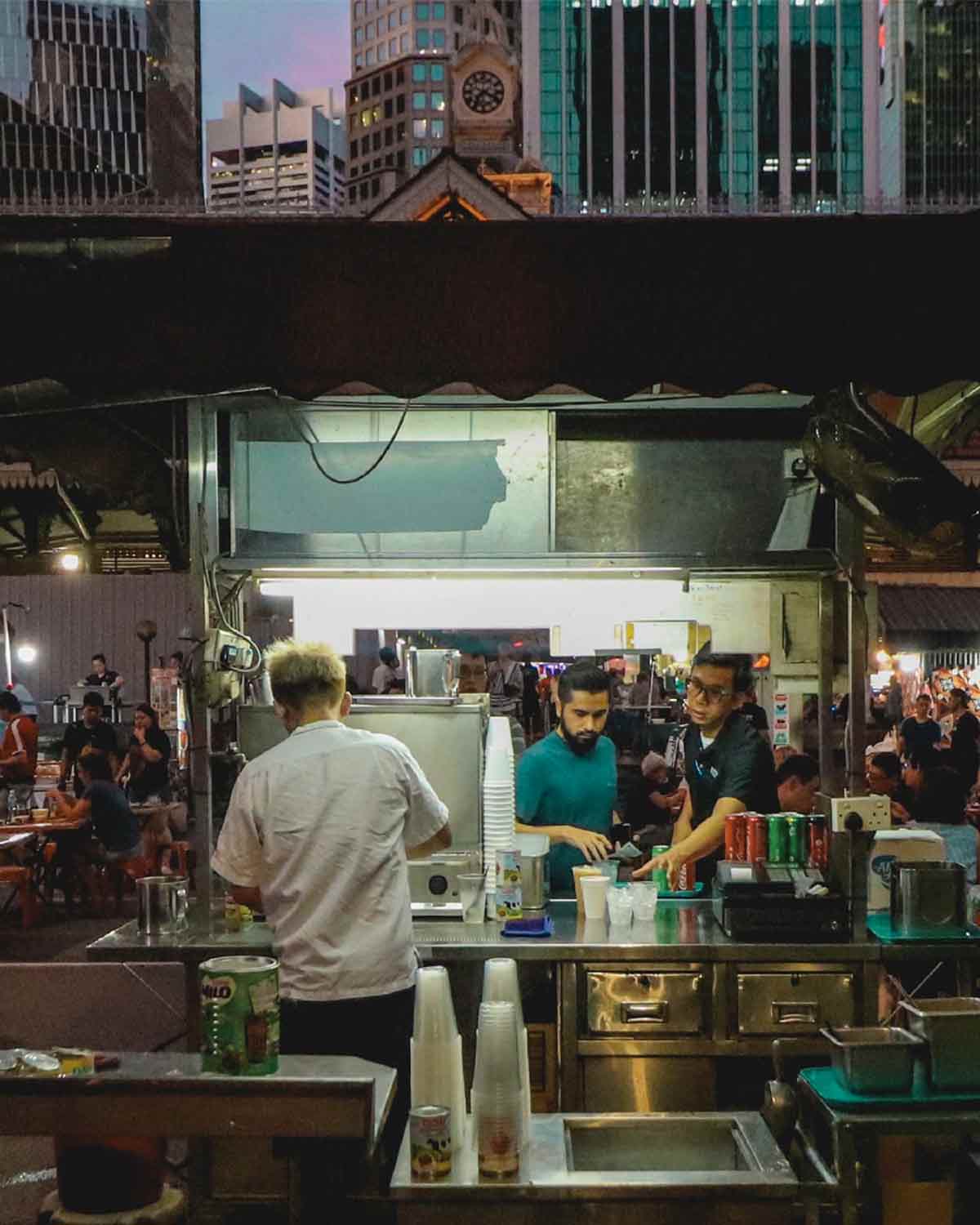 An energetic photo of street food vendors in Singapore.