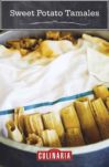 Sweet potato tamales nestled in a pot with a towel covering them.