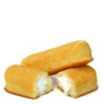 Two homemade Twinkies, with one cut in half and the other resting on top of a cut half.