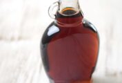 A glass bottle filled with maple syrup, as illustration of how to store your maple syrup.