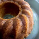 A rum cake in a grey bowl.