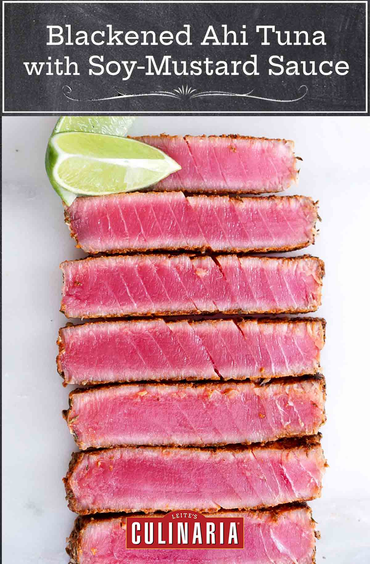 Slices of blackened ahi tuna with soy-mustard sauce lined up next to each other with two lime wedges on the side.