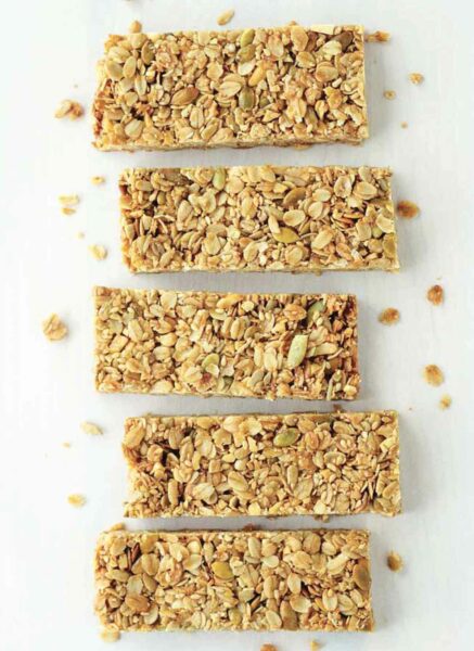 Five cinnamon granola bars arranged side by side.