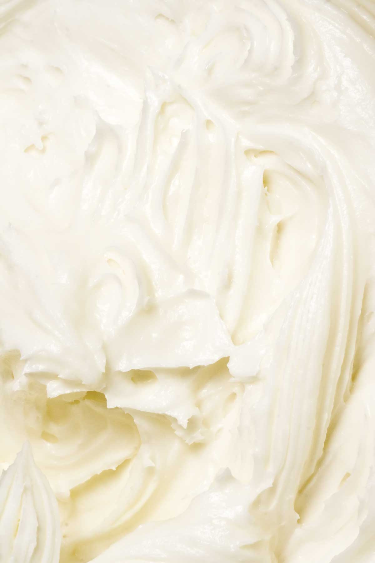 A close view of swirled cream cheese frosting.