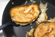 Two Hog Island grilled cheese sandwiches in a skillet with some cheese melting from them.