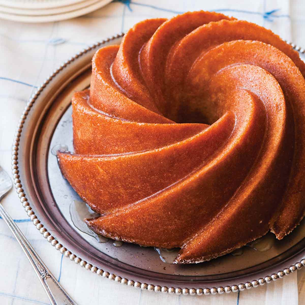 A fancy Bundt Kentucky bourbon cake on a silver platter.