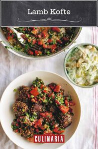 A white bowl filled with lamb kofte and parsley and tomato salad.