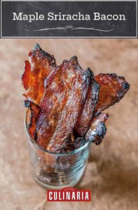 Several slices of maple sriracha bacon in a glass.