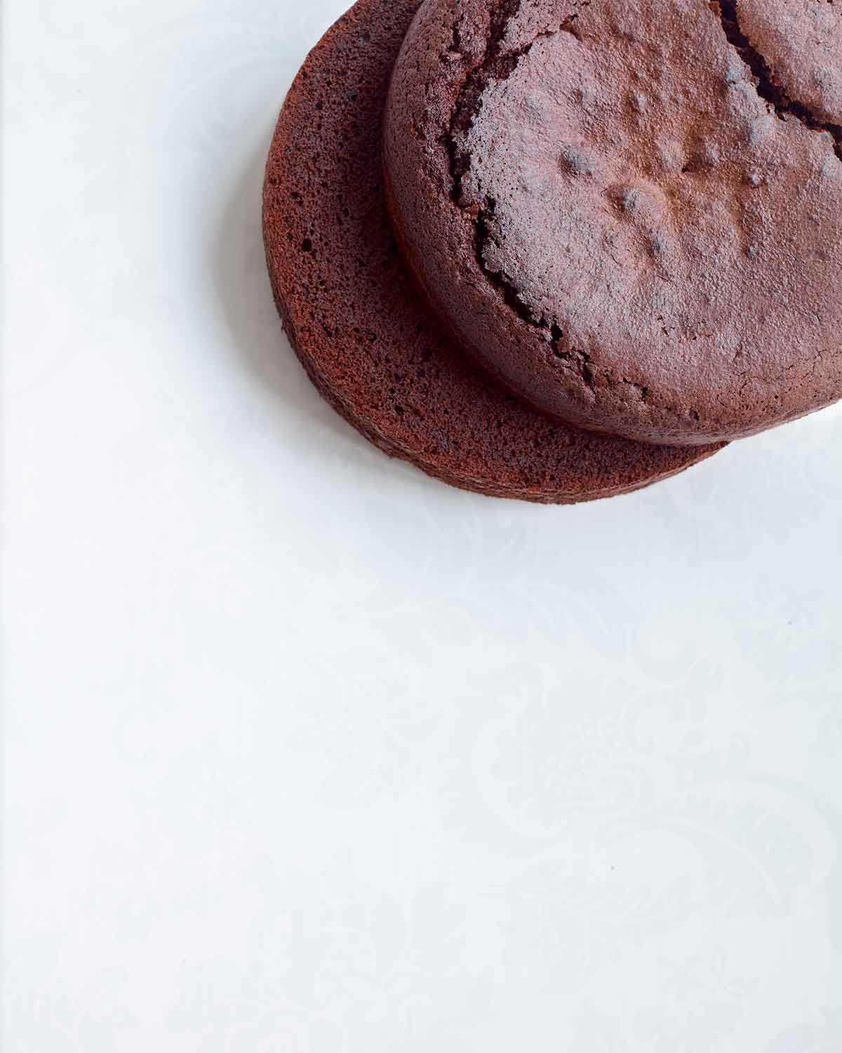 Two vegan chocolate cakes stacked on top of each other.