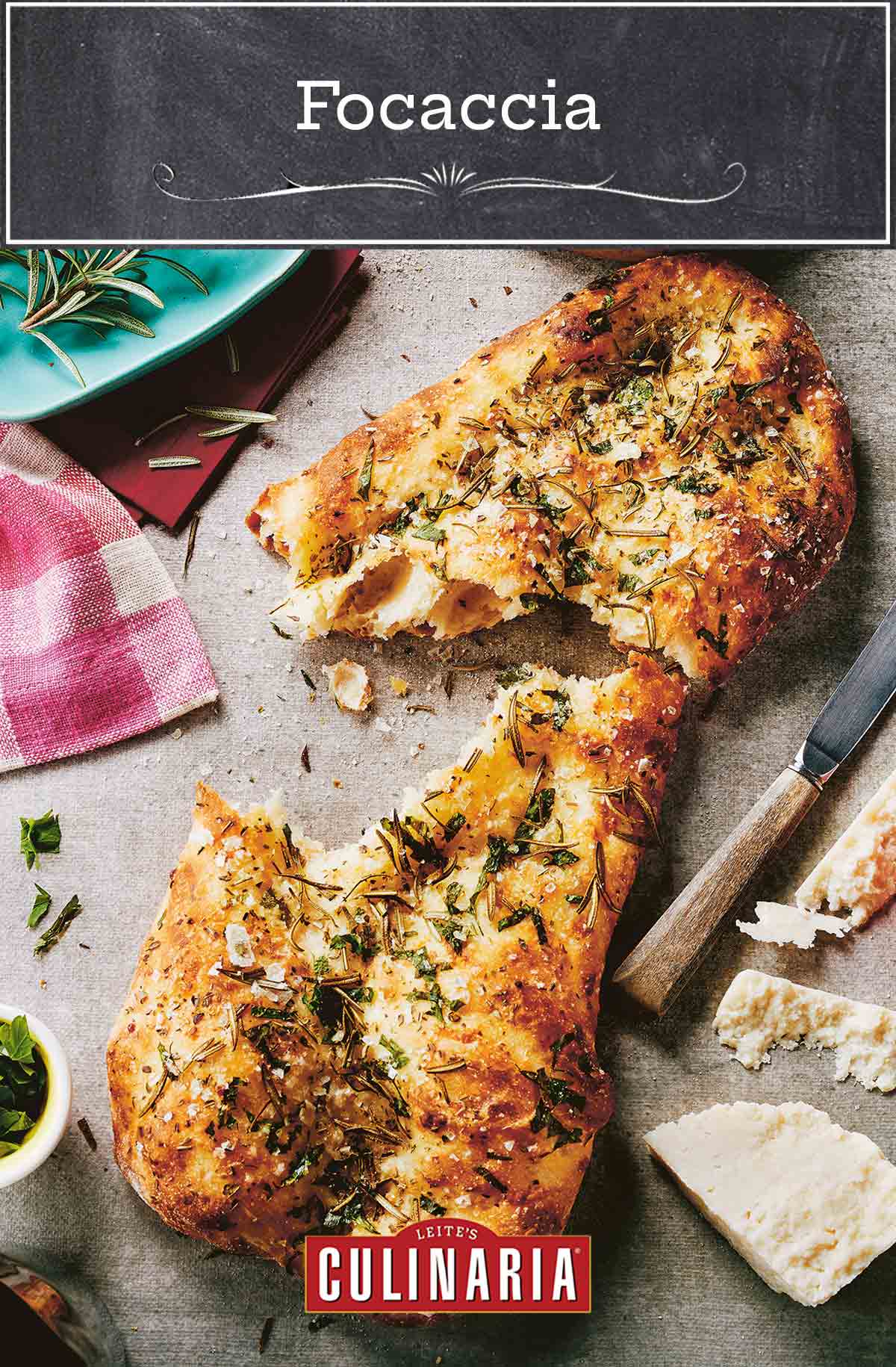 A torn loaf of focaccia with herbs and salt and sprigs of rosemary, a knife, and a hunk of pecorino on the side.