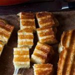 A grilled cheese sandwich cut into cubes of grilled cheese croutons.