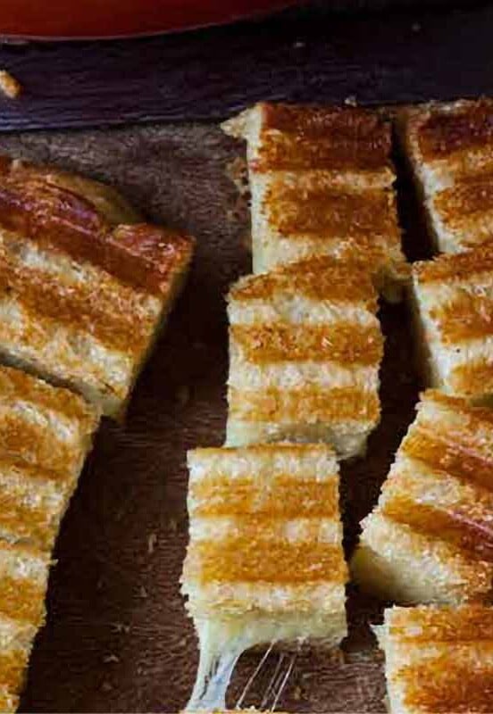 A grilled cheese sandwich cut into cubes of grilled cheese croutons.