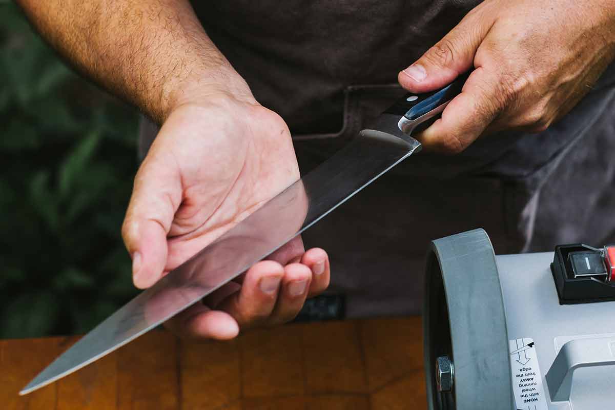 A man from KnifeFlight holding a newly sharpened knife