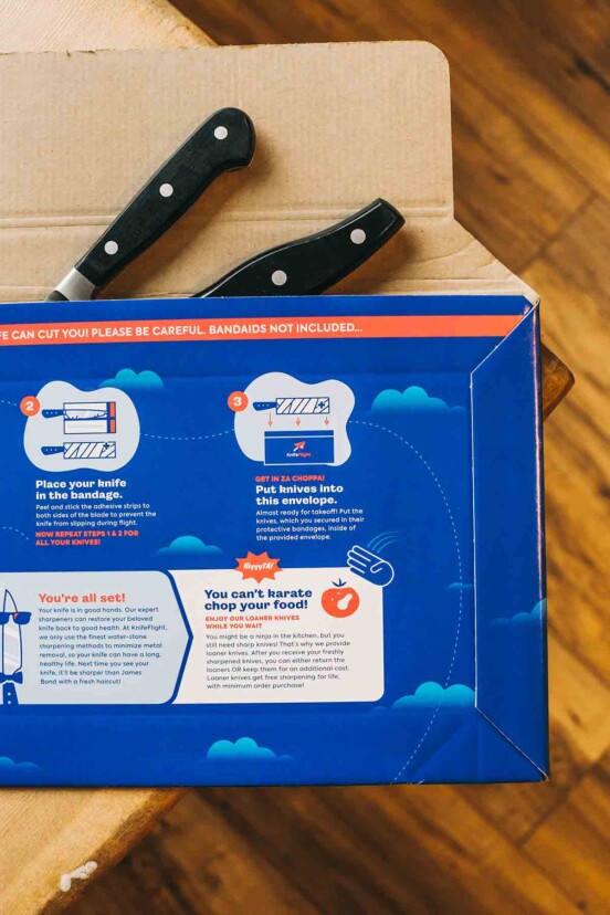 A KnifeFlight mailing package with the handles of two knives sticking out.