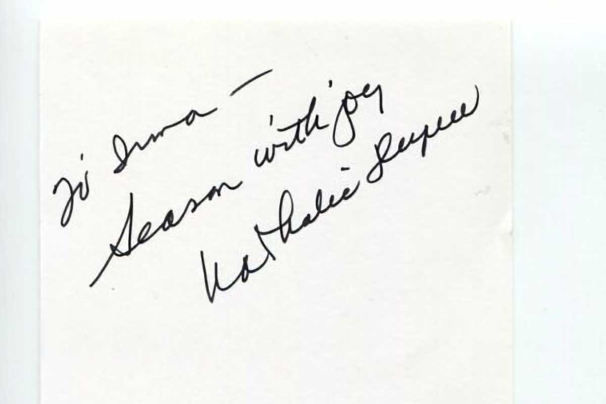 An autograph from Nathalie Dupree inside a book cover.