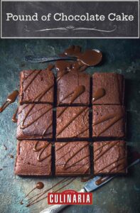 A pound of chocolate cake cut into nine squares and drizzled with chocolate ganache.