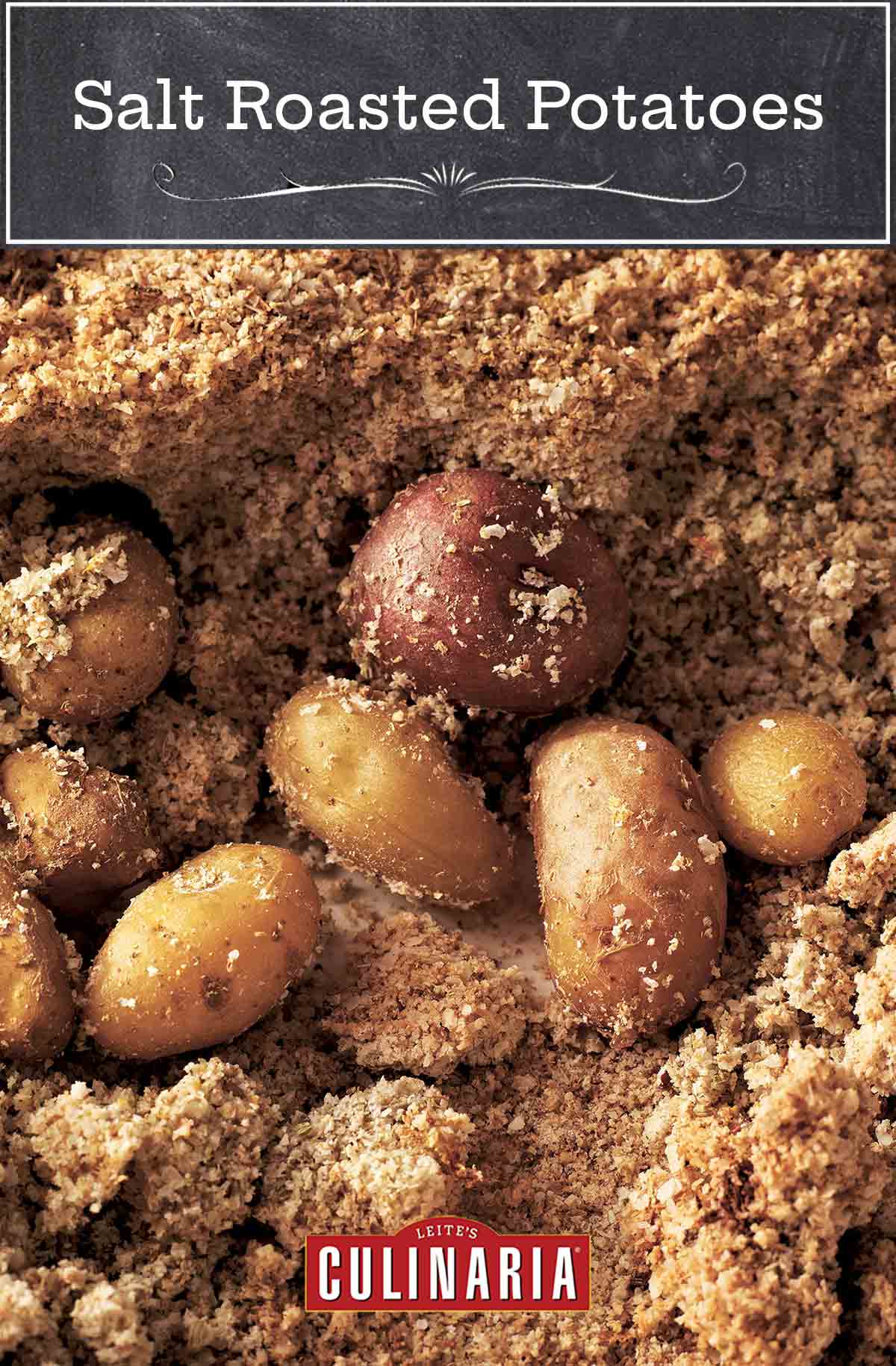 Several small salt-roasted potatoes surrounded by a bed of browned salt.