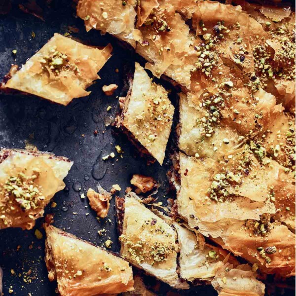 Diamond-shaped pieces of walnut baklava, topped with chopped pistachios.
