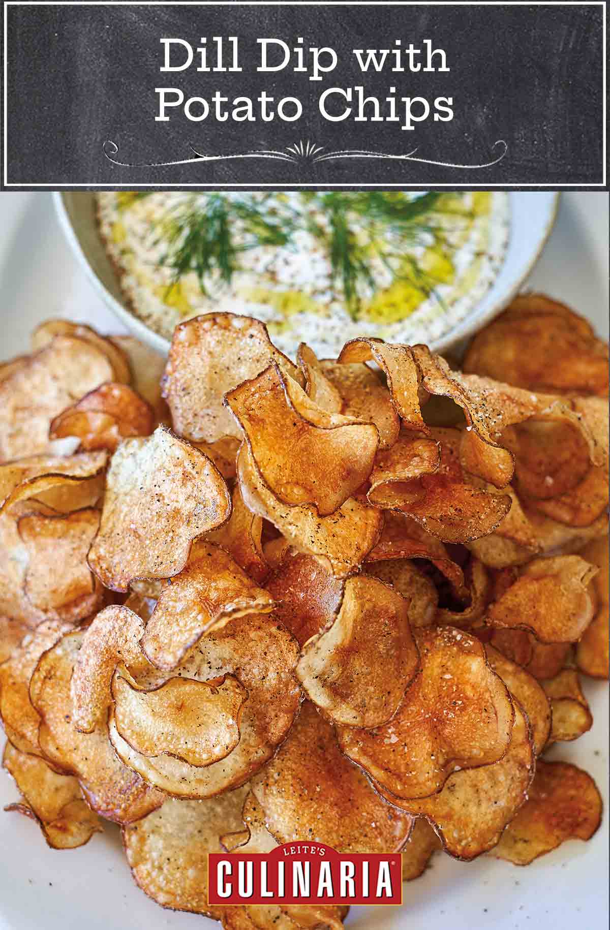 A white oval platter holding a bowl of dill dip with potato chips beside it.