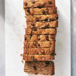 A loaf of gluten-free chocolate chip banana bread cut in to 10 slices.