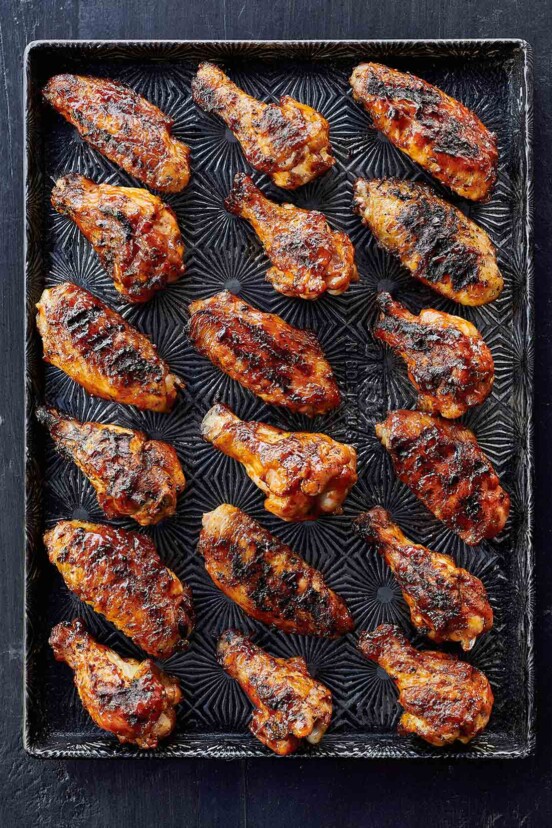 A tray with 18 grilled chicken wings with maple bourbon sauce.