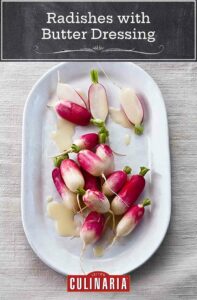 A white oval platter topped with French breakfast radishes with butter dressing.