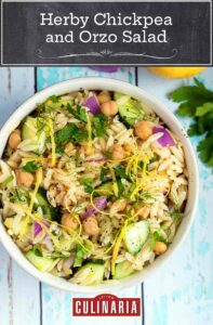 A white bowl filled with vegan chickpea and orzo salad with lemon zest garnish.