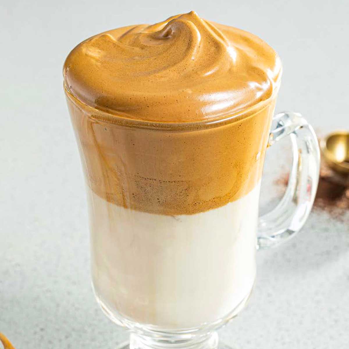 An Irish coffee glass filled with whipped coffee.