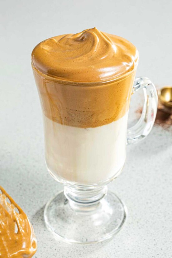 An Irish coffee glass filled with whipped coffee.
