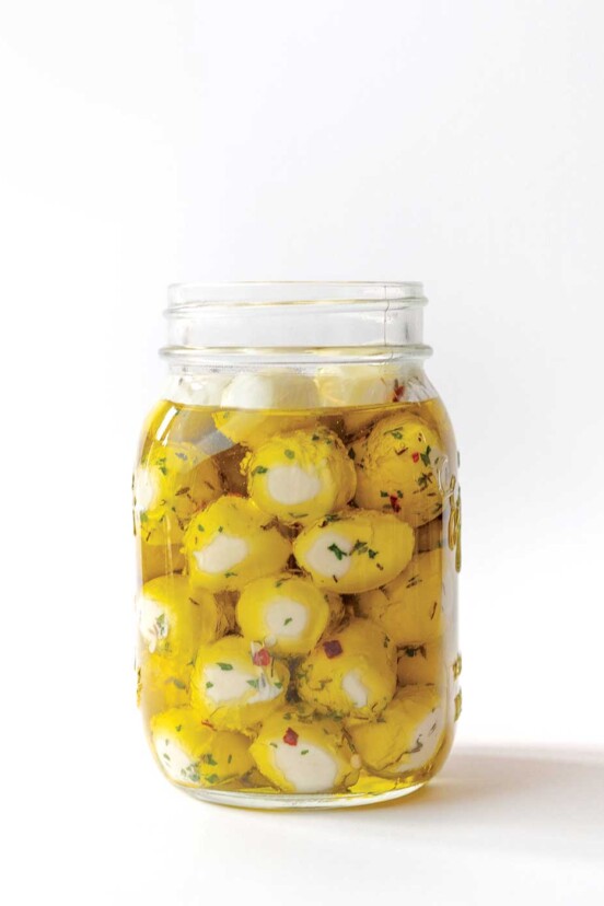 A jar of Armenian yogurt cheese balls in oil.