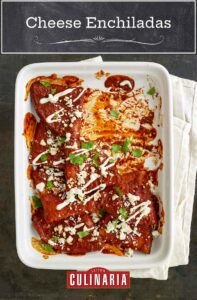 A white casserole dish partially filled with cheese enchiladas, garnished with cilantro, cheese, and crema.