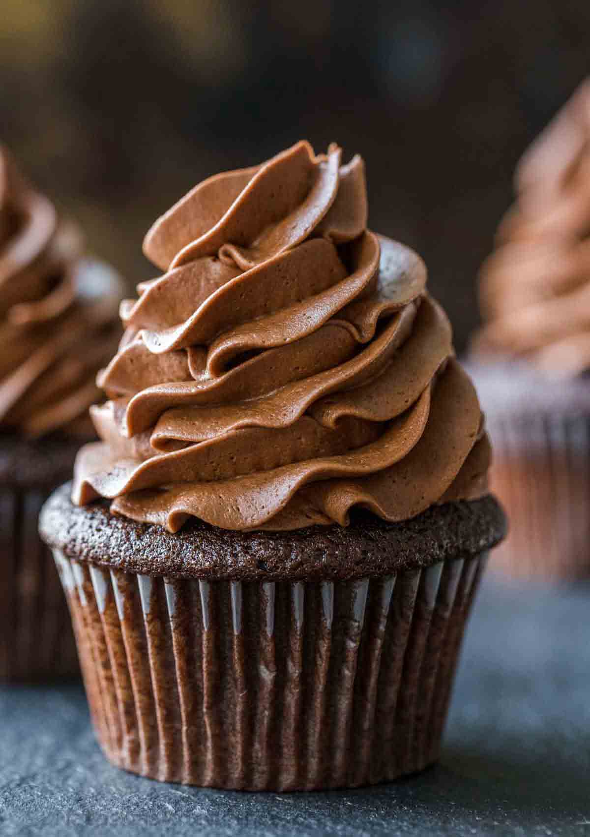 Three easy chocolate cupcake with chocolate buttercream on top.
