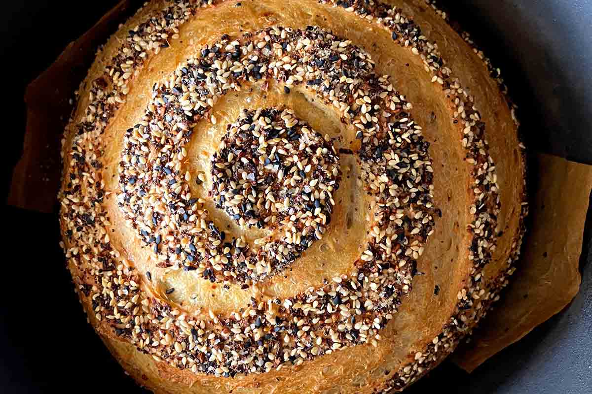 Overhead of a swirled no-knead everything bagel bread loaf.
