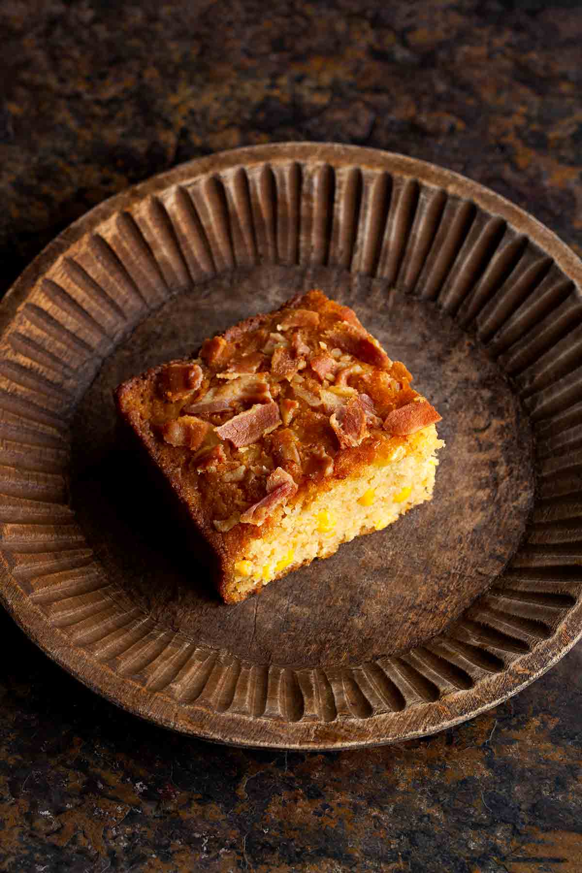 A small, rustic tart tin with one square of bacon cornbread.