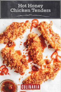 5 panko breaded chicken breasts drizzled with deep red hot sauce and chili slices, plus a bowl of spicier honey.