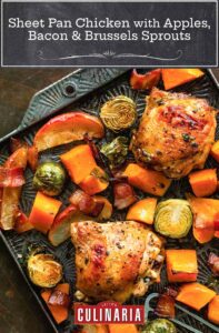 A sheet pan filled with roasted chicken thighs, apples, bacon, Brussels sprouts, and sweet potatoes.