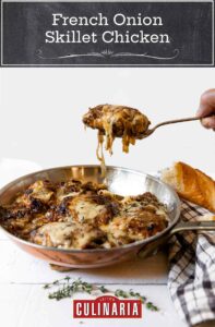 French onion skillet chicken in a copper frying pan with a person lifting out a serving
