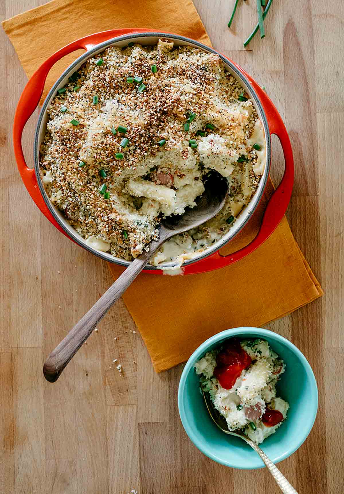 A red bowl of Molly Yeh's everything bagel mac and cheese on an orange napkin.