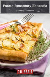 A purple napkin with a white plate on top, with a slice with potato rosemary focaccia garnished with rosemary and with a fork on top.