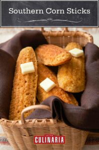 A woven basket of Southern corn sticks, lined with brown napkins. Pats of butter melt on top.