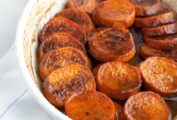 Bourbon sweet potatoes in a white oval baking dish.