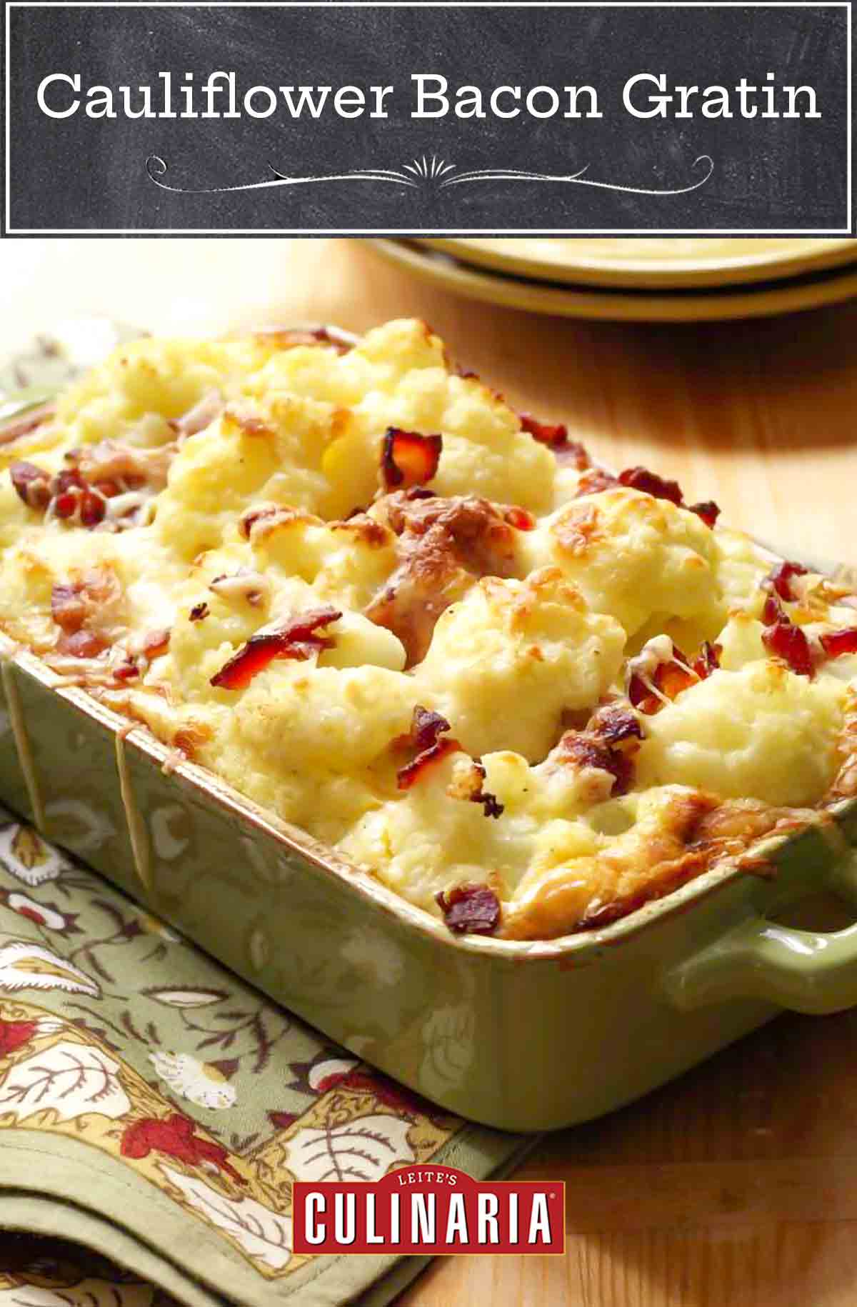 Cauliflower bacon gratin in a large green rectangular baking dish with melted cheese.