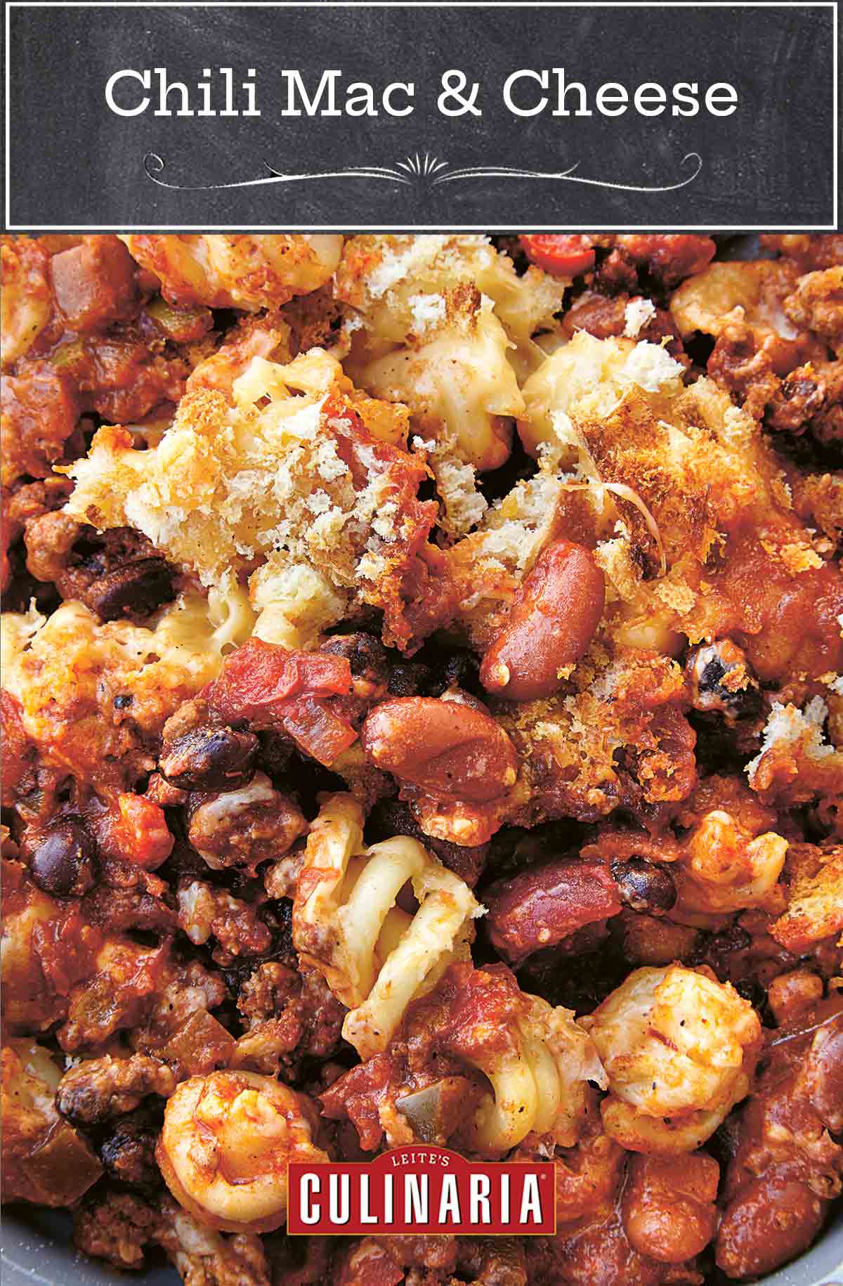 Chili mac and cheese in close-up with bread crumbs and melted cheese.
