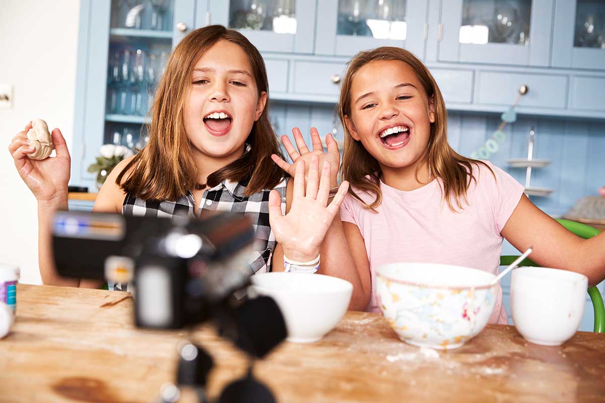 Two children participating in a virtual cooking club.