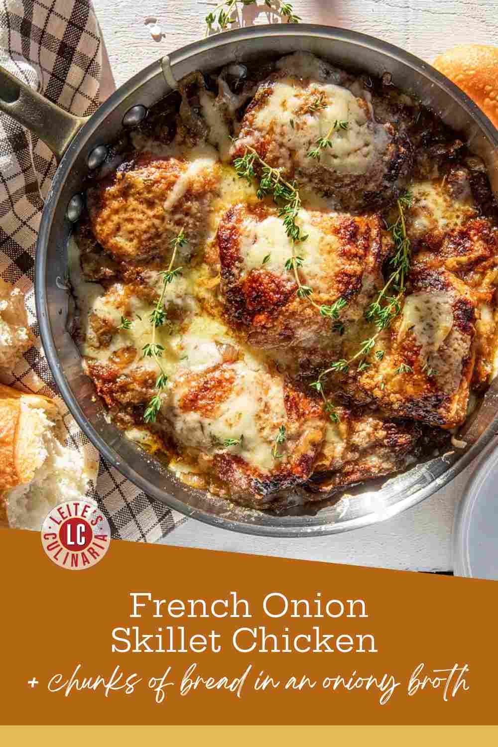 Golden seared chicken thighs in a skillet with caramelized onions, melted cheese, and fresh thyme sprigs.