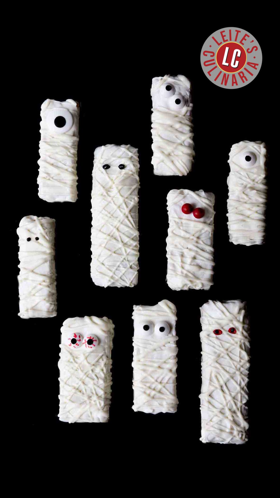 Nine Halloween mummy Rice Krispies treats with googly candy eyes on a black background.