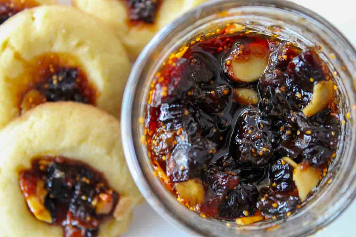 Fig jam thumbprint cookies beside a jar of Lebanese fig jam.