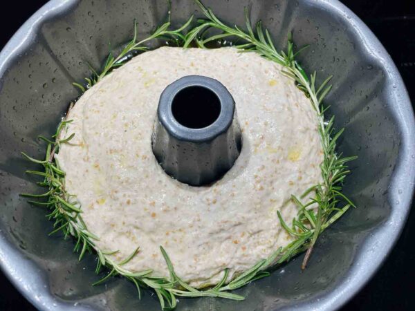a Bundt pan with rosemary-garlic sourdough dough