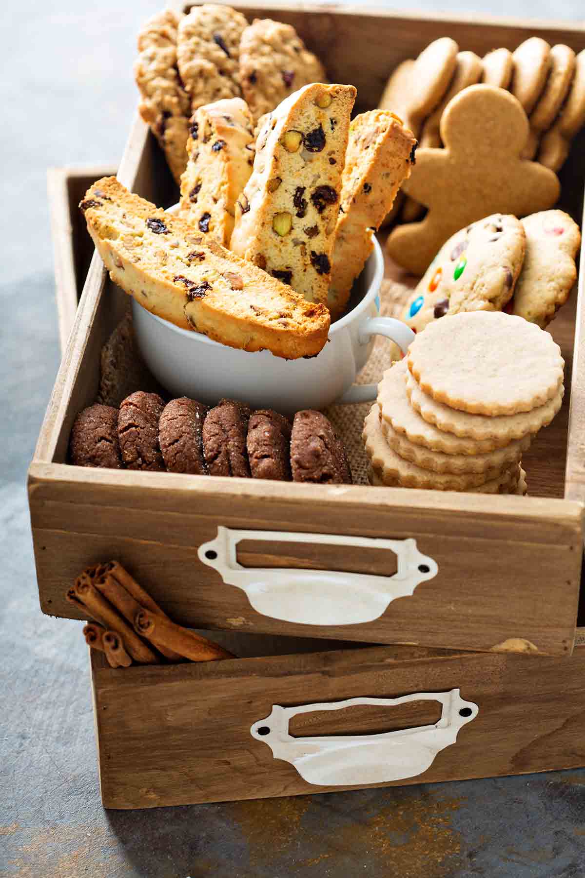 Two wooden trays filed with holiday cookies for a cookie swap