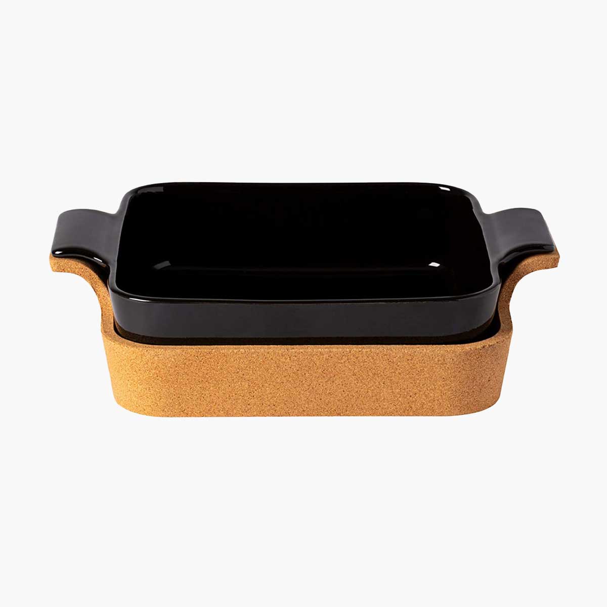 A rectangular black casserole dish in a cork tray, one of Oprah's 12 favorite kitchen gifts for 2021.
